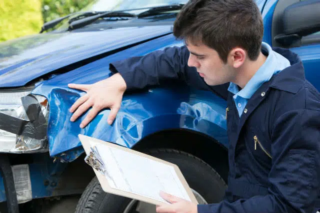 Consultant inspecting vehicle